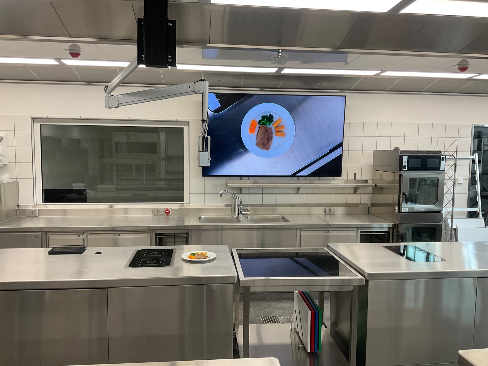 Kitchen area at BBS III Lüneburg, showing EYE-14 camera with custom swivel arm positioned above the working surface.